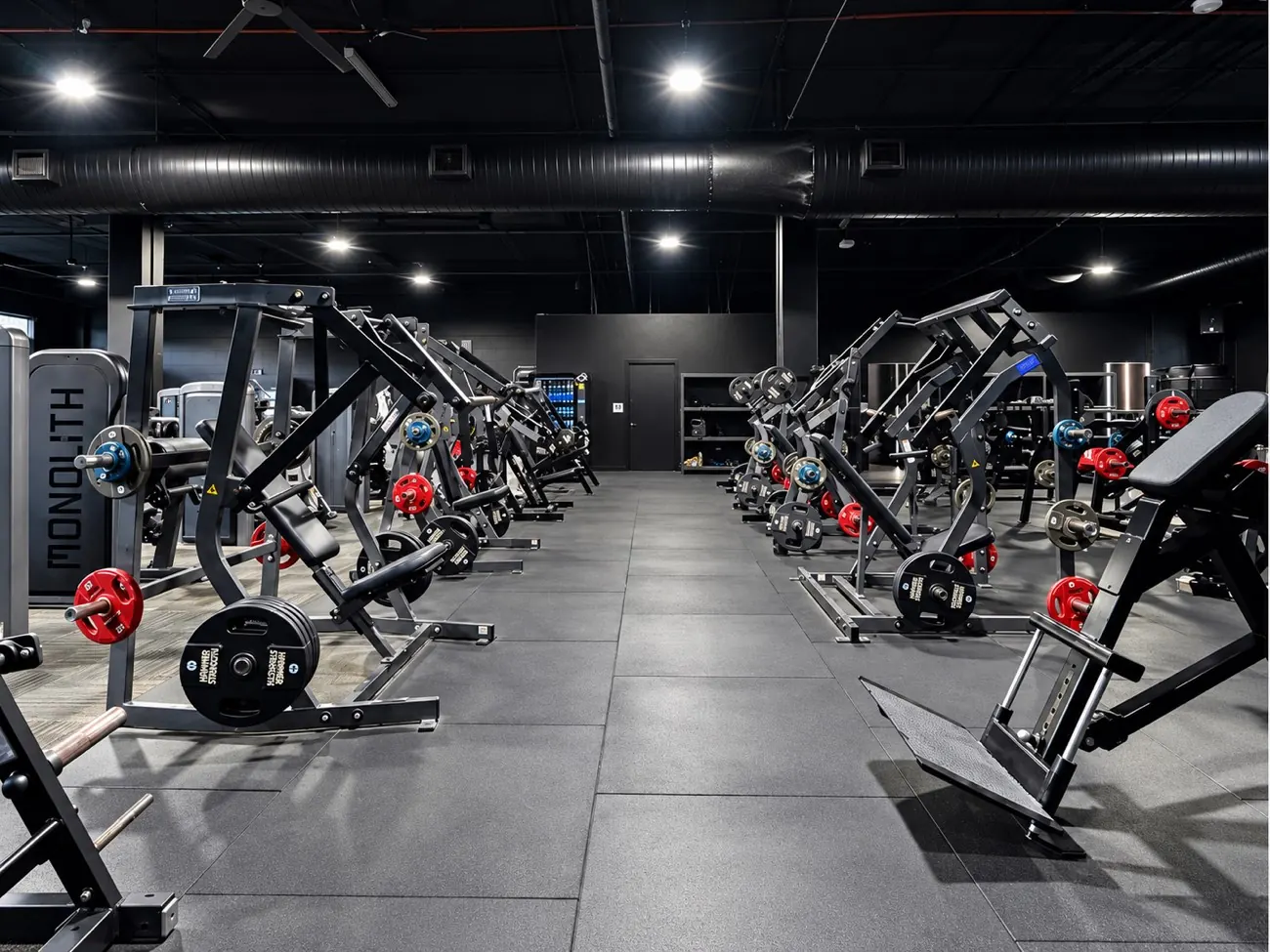 Strength training area with weight machines at MVMNT